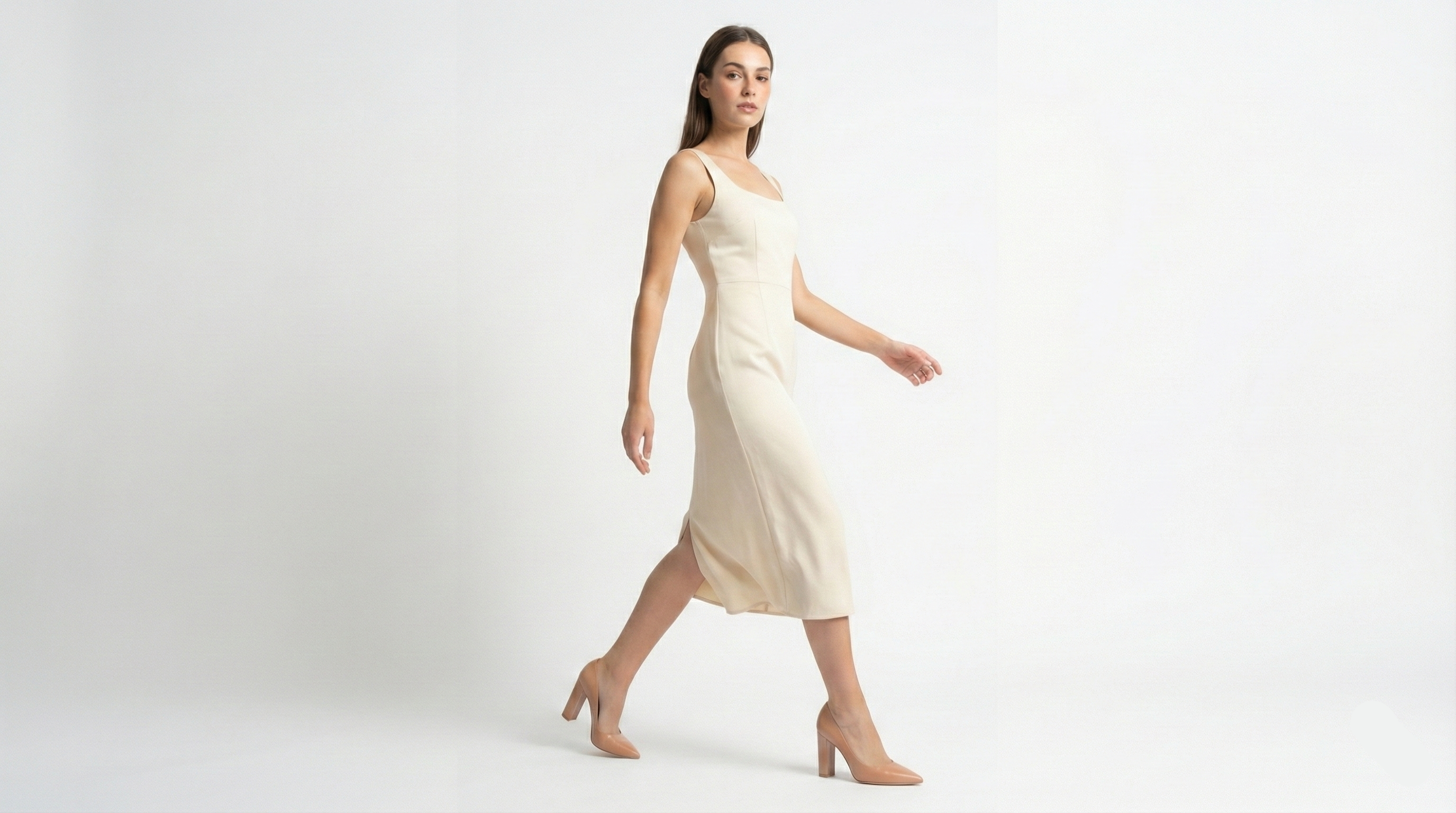 Woman wearing a cream-colored dress on a white background