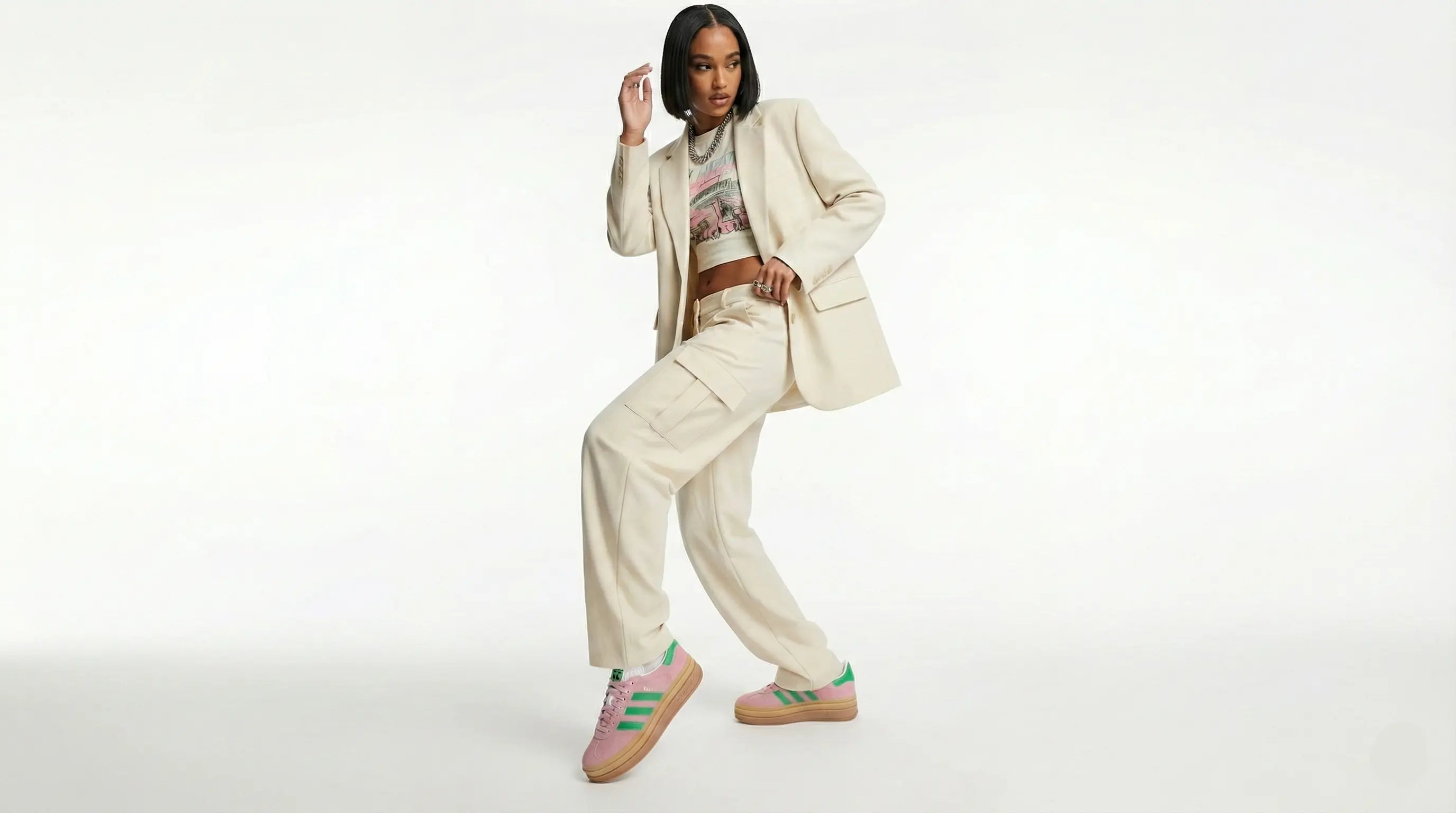 Person wearing a beige suit with colorful sneakers on a white background