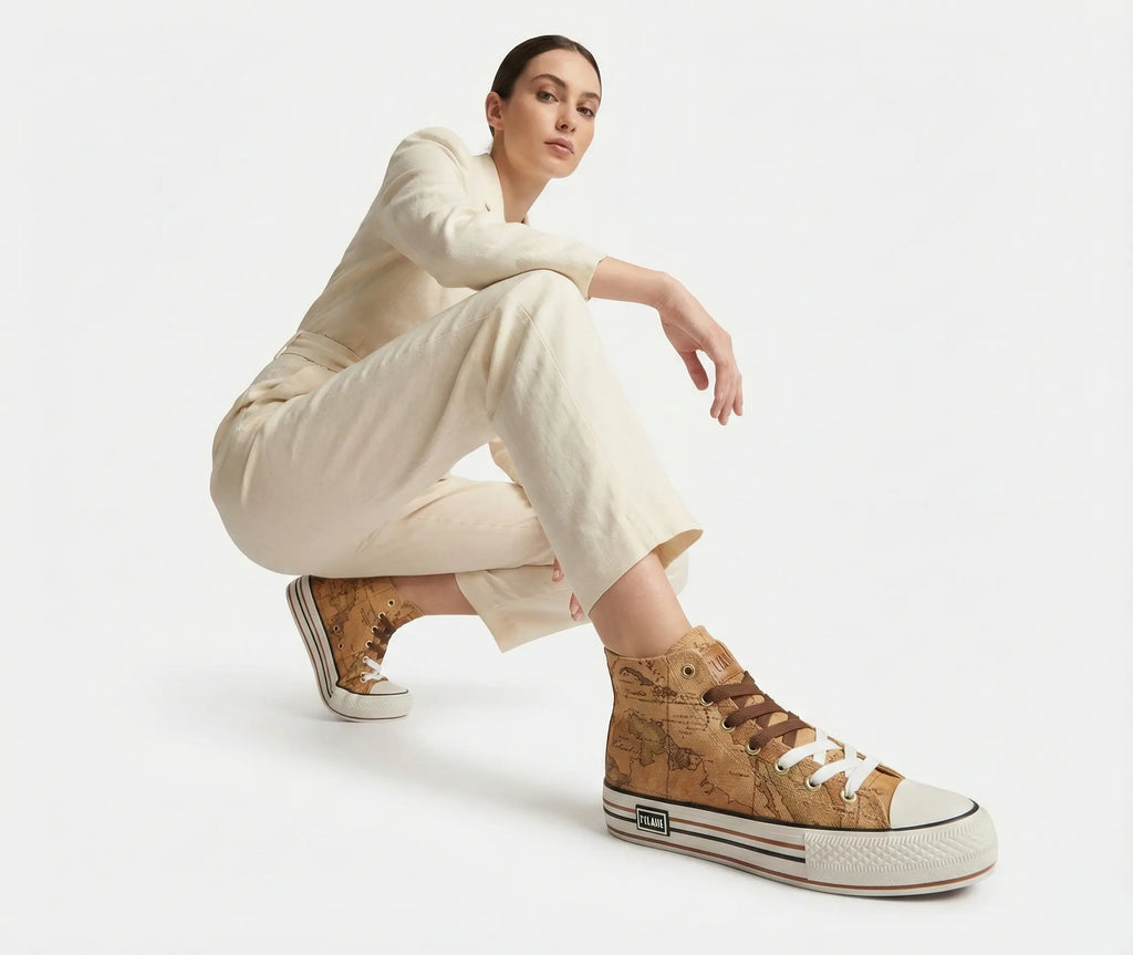 Woman wearing beige high-top sneakers on a white background